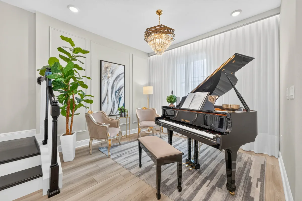Piano room with chandelier
